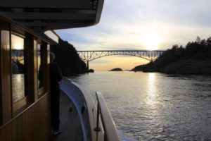 Side deck view to Deception Pass bridge Anacortes at sunset - Classic yacht MV Discovery